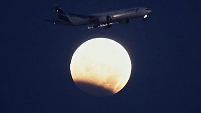 Near-total lunar eclipse as moon passes through Earth’s shadow